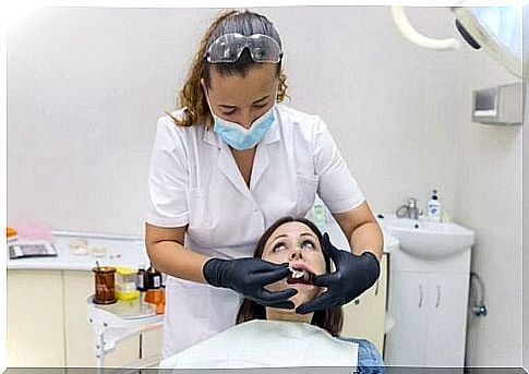 Woman undergoing tooth extraction