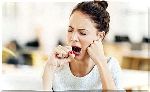 A woman yawning.